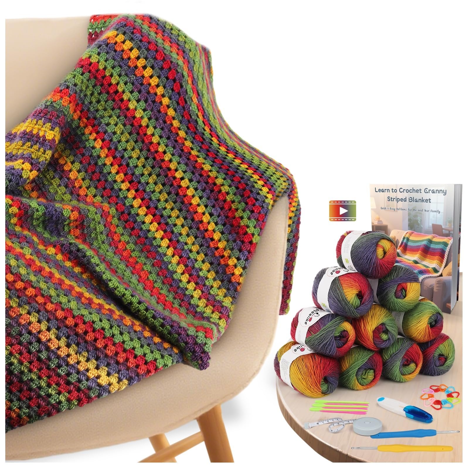 Crocheted blanket draped over a chair next to a display of yarn skeins and crochet tools.
