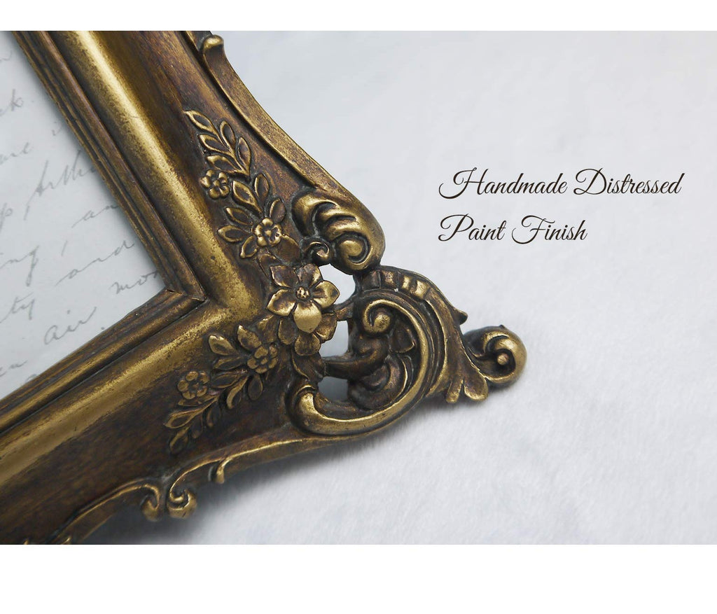 Close-up of a vintage-style ornate picture frame with floral details in an antique gold finish.
