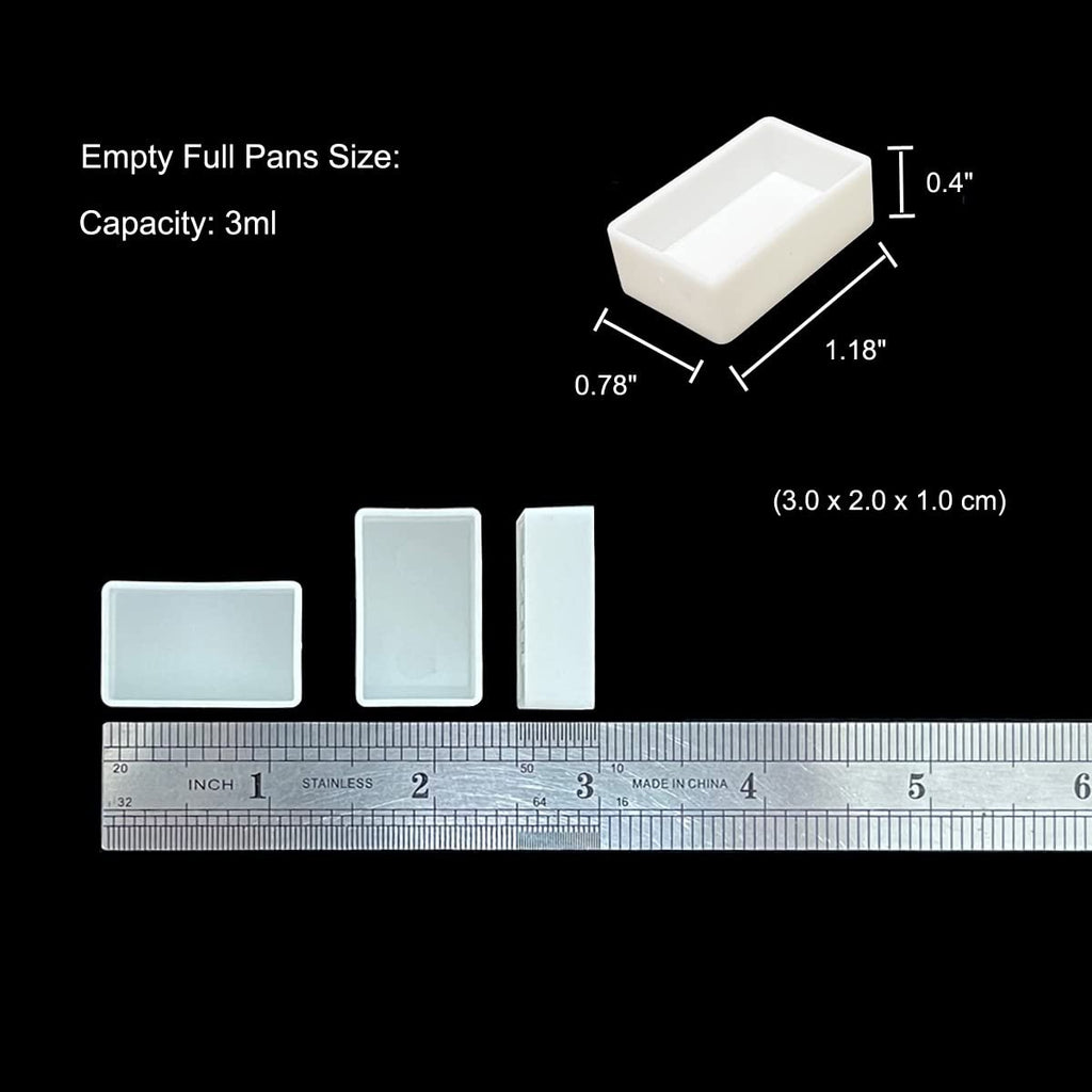 Three empty watercolor paint pans shown with dimensions and a ruler for scale. One pan is shown from an angled top-down view with dimensions 0.78" x 1.18" x 0.4". Two pans are shown from the side and front, placed above a ruler marked in inches and centimeters. Text indicates capacity is 3ml.