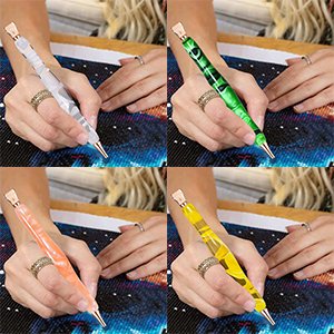 Four diamond painting pens in different colors being held by hands working on a diamond painting canvas