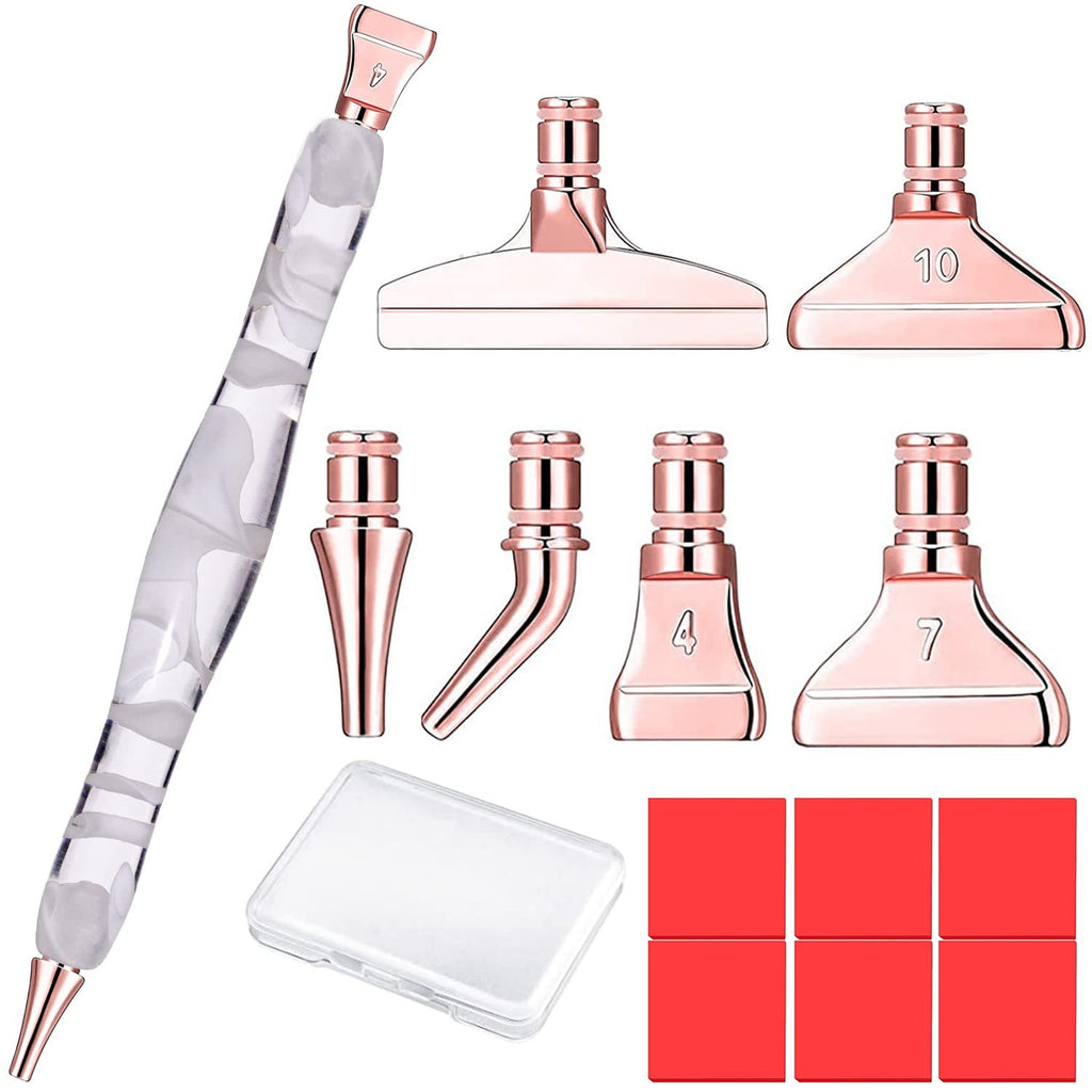 Diamond painting pen kit with rose gold tips and accessories including a storage box and red squares.