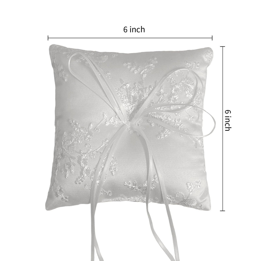 White satin ring bearer pillow with floral lace embroidery and ribbon bow, shown with 6-inch dimensions indicated.