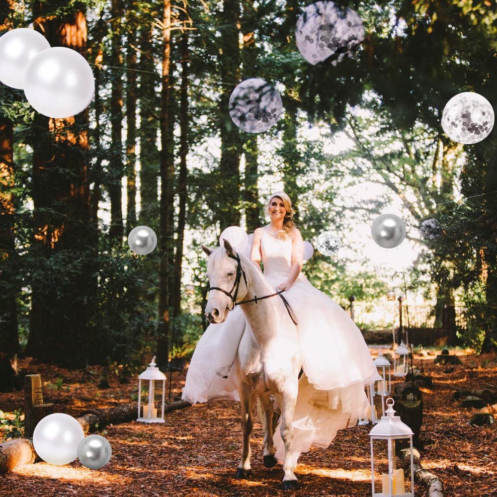 Bride on a white horse in a forest setting with decorative balloons and lanterns