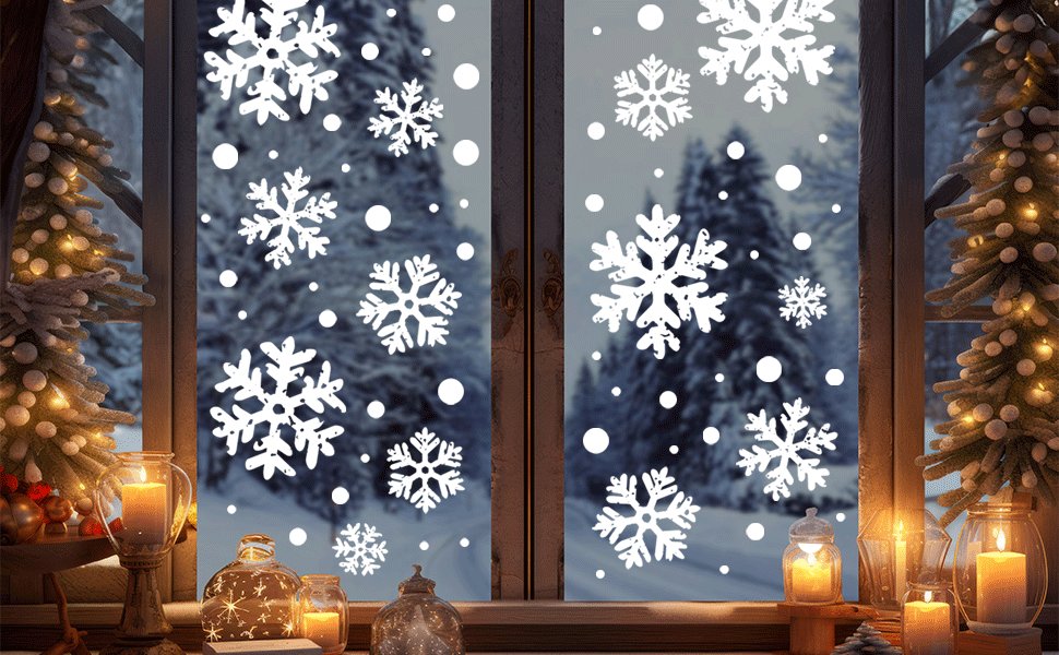 White snowflake window clings applied to a window with a snowy forest and Christmas trees visible outside.