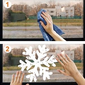 Two-panel image showing how to apply white snowflake window clings. Top panel: hand cleaning a window with a blue cloth. Bottom panel: hands placing a large snowflake cling onto the clean window.