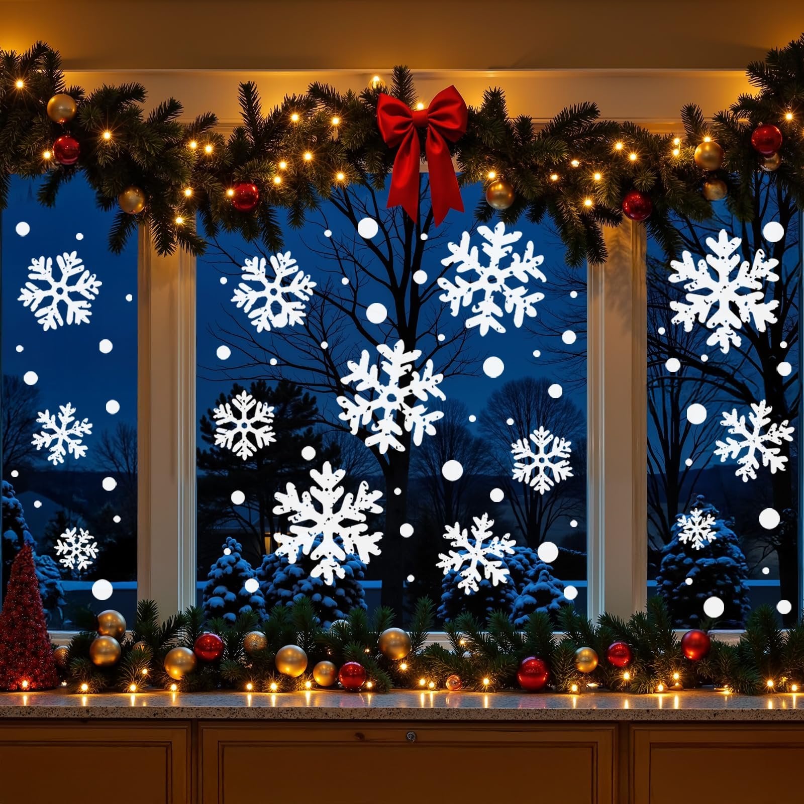 Christmas window decorated with white snowflake clings, garland, lights, and ornaments