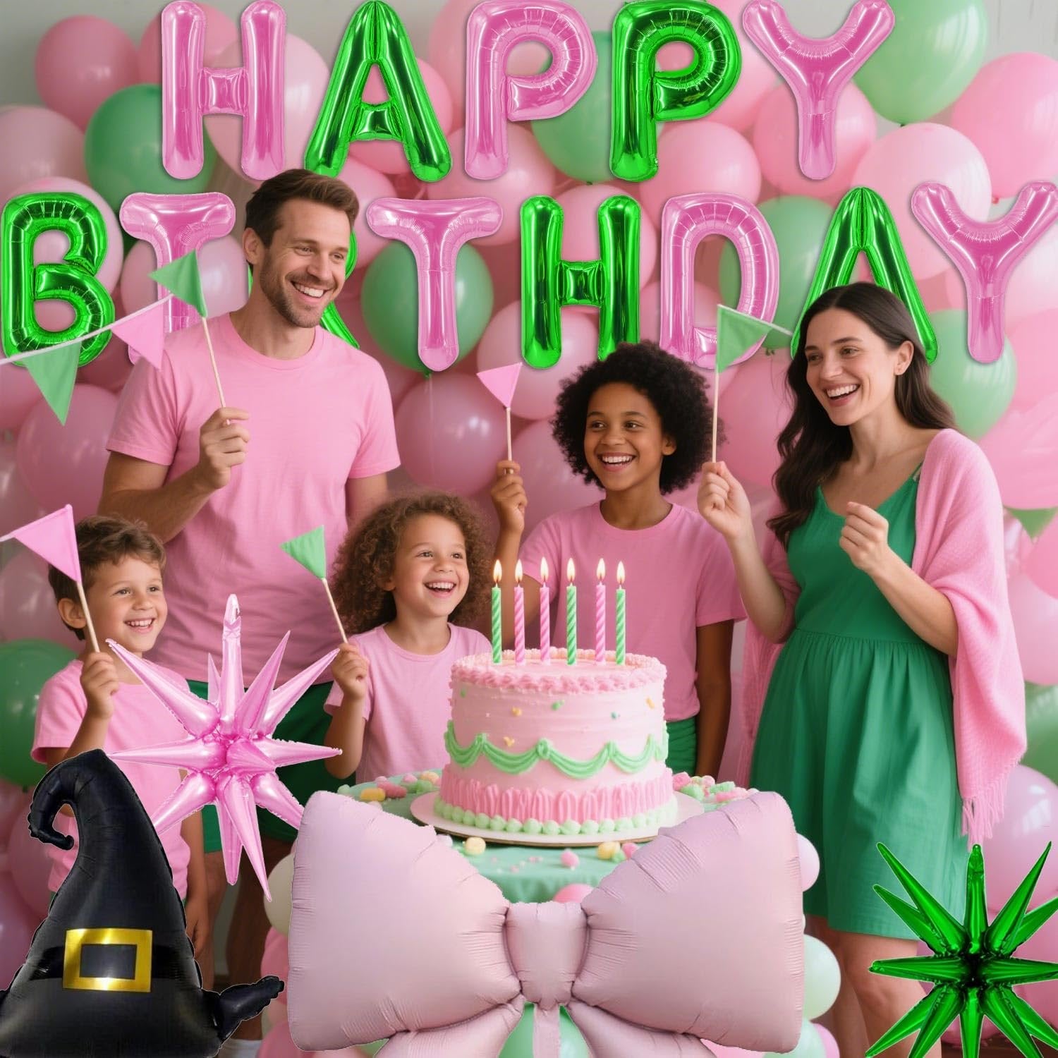 Family celebrating a birthday with pink and green balloons, a cake, and foil balloons shaped like a witch hat and bow.