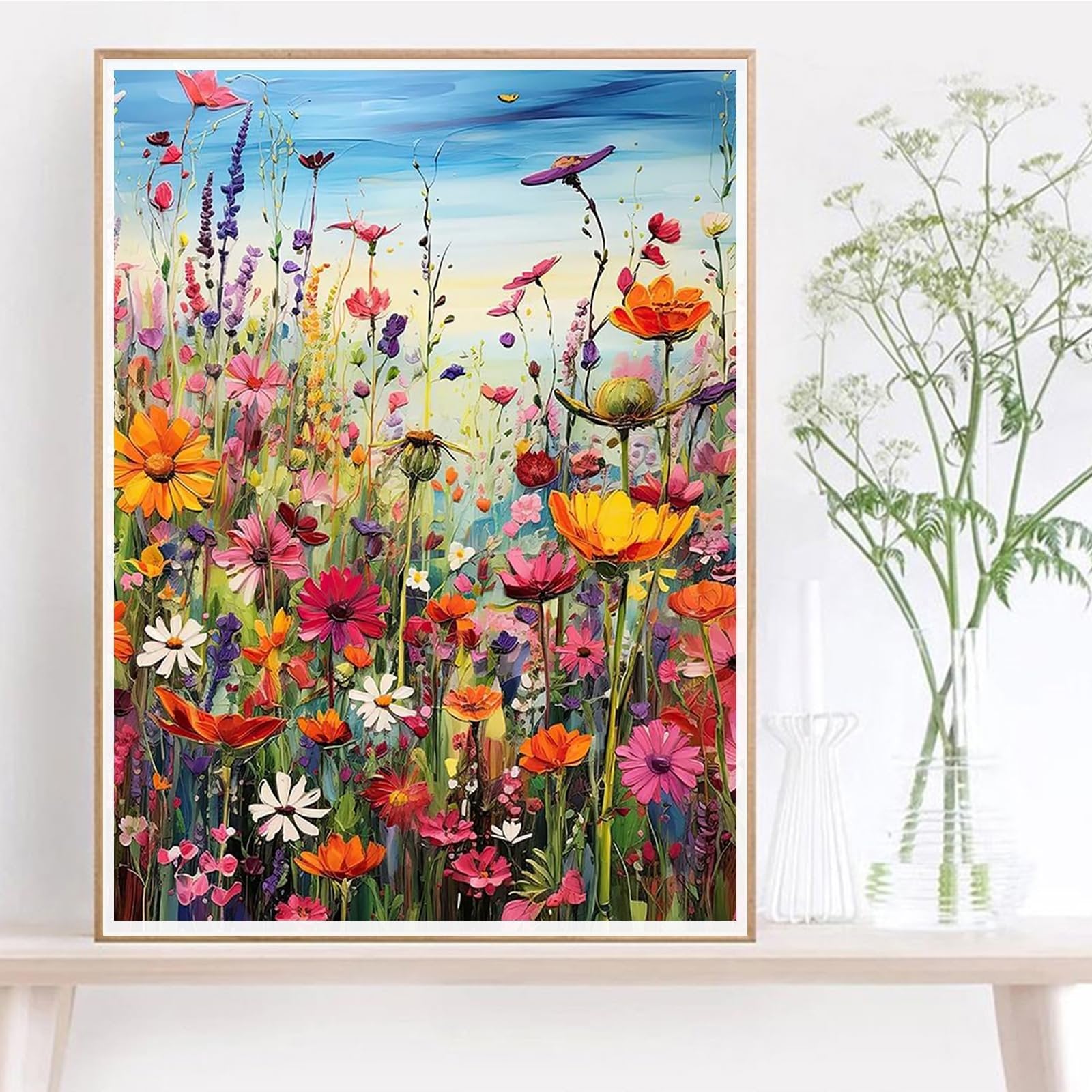 Vibrant impressionist painting of a wildflower meadow under a blue sky, featuring a variety of colorful flowers and greenery.