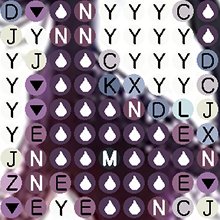 Diamond painting canvas grid with symbols and letters, close-up view