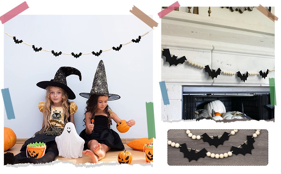Two young girls in witch hats and Halloween costumes sit on the floor with a bat and bead garland hanging above them.