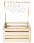 Wooden baby shower crate with a rack of white hangers inside, front view