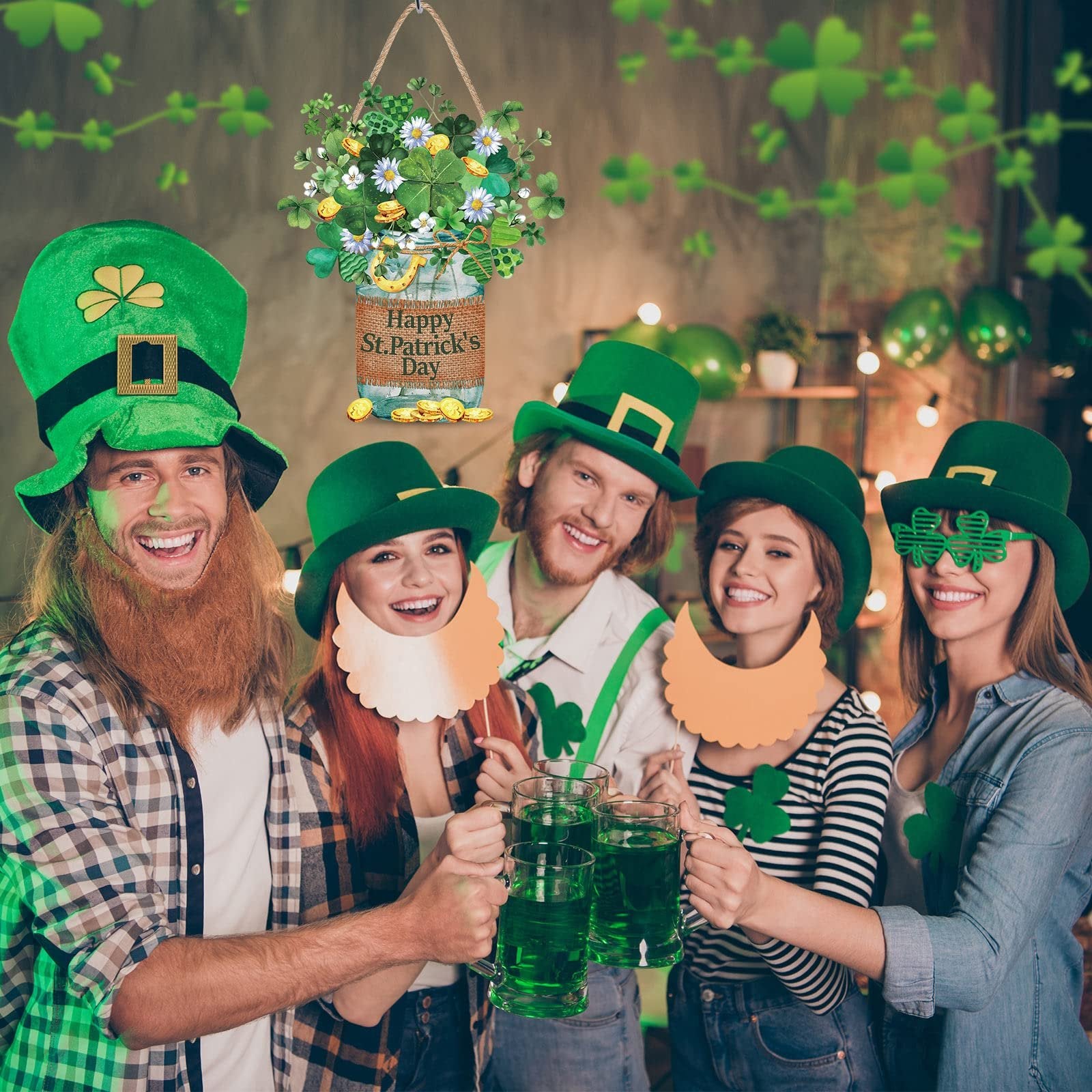 Group of people celebrating St. Patrick's Day with green hats and drinks, featuring a hanging wooden sign.