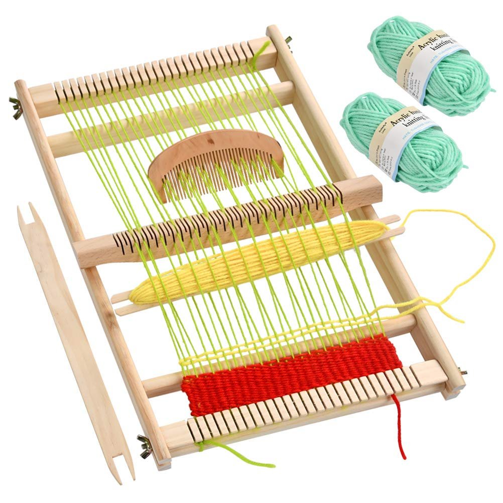 Wooden weaving loom with stand, comb, shuttles, and two balls of mint green yarn, partially woven with red and yellow yarn.