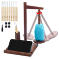 Wooden yarn holder with crochet hooks, phone stand, and blue yarn ball on white background
