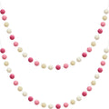 Two strands of wool felt pom pom garland in pink, light pink, beige, and white, displayed against a white background.