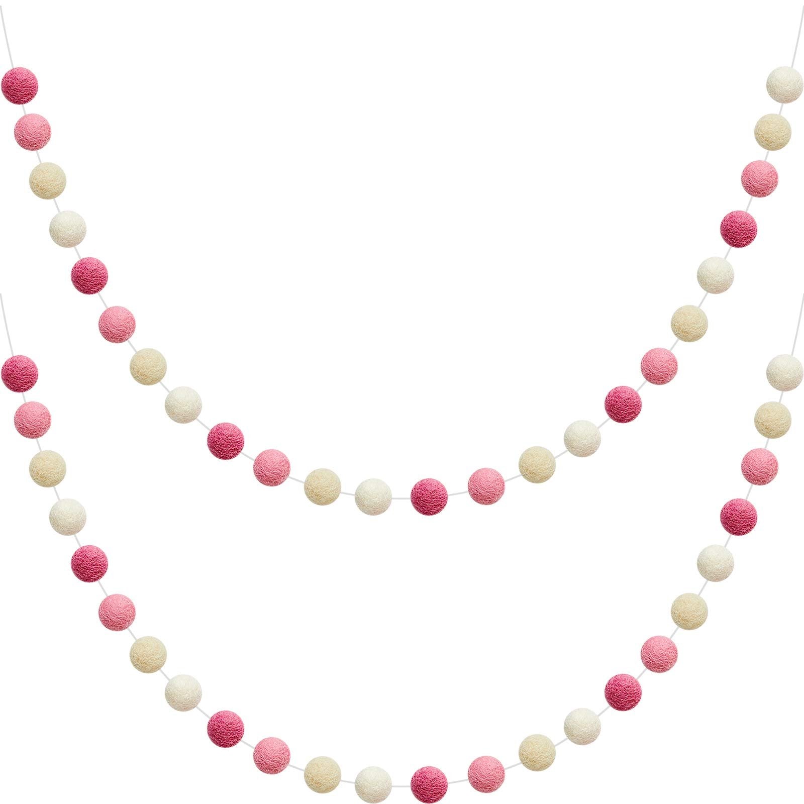 Two strands of wool felt pom pom garland in pink, light pink, beige, and white, displayed against a white background.